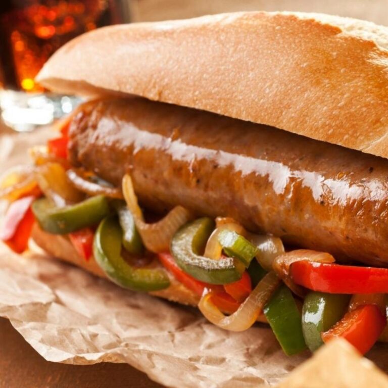 closeup of air fryer Italian sausage with peppers on a bun
