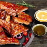 air fryer bbq ribs brushed with BBQ Sauce and served with lemon and sauce on the side