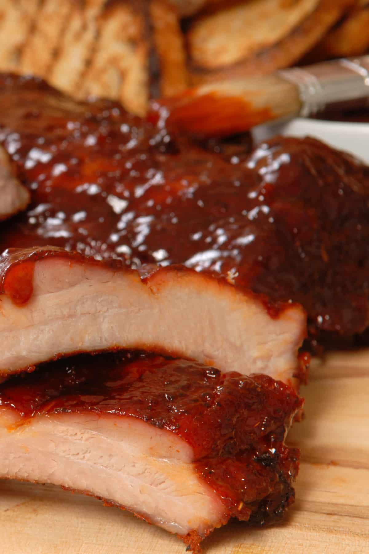 Carved BBQ Ribs basted with Easy Homemade BBQ Sauce cut into ribs and ready to eat.