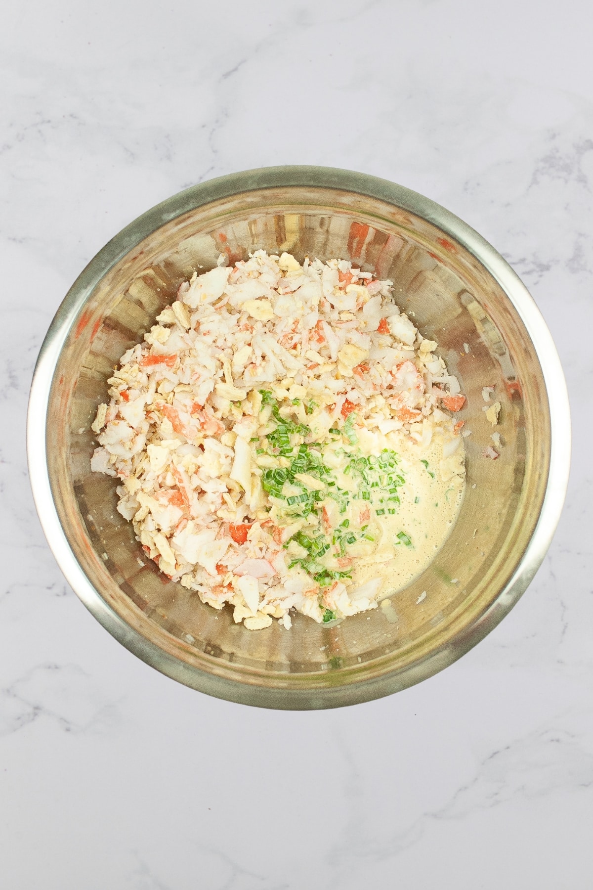 crab meat, crackers, and green onions in a mixing bowl