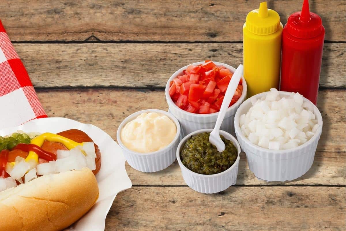 assorted brat condiments on a wooden table