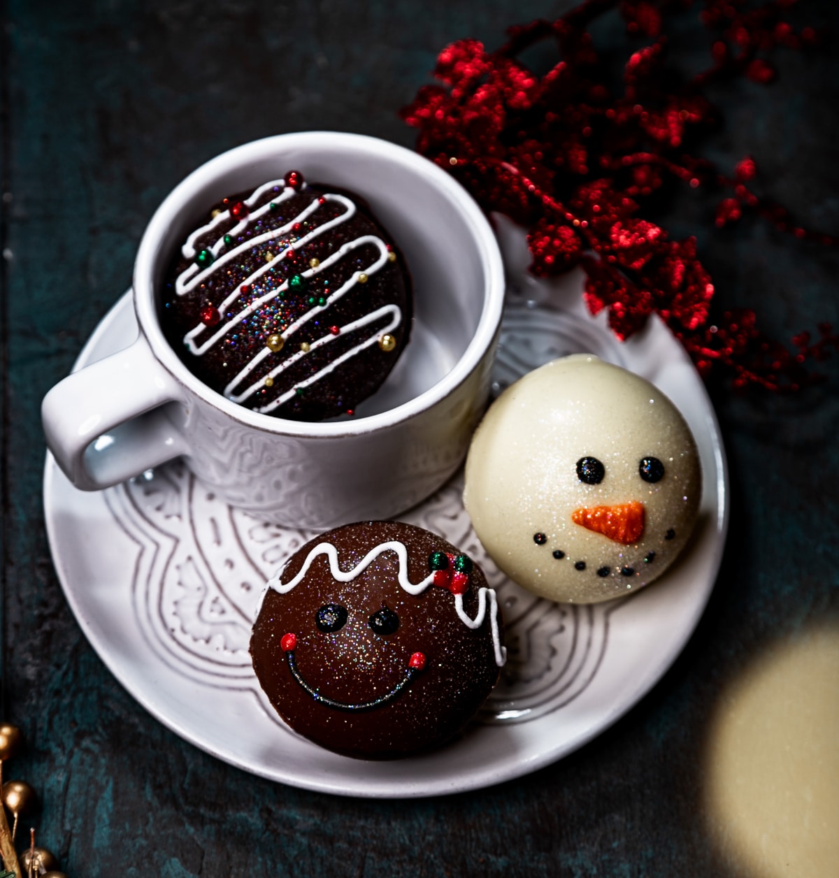 Decorated Hot Chocolate Bomb with 1 hot chocolate bomb in mug. 2 chocolate bombs with cute snowman faces.