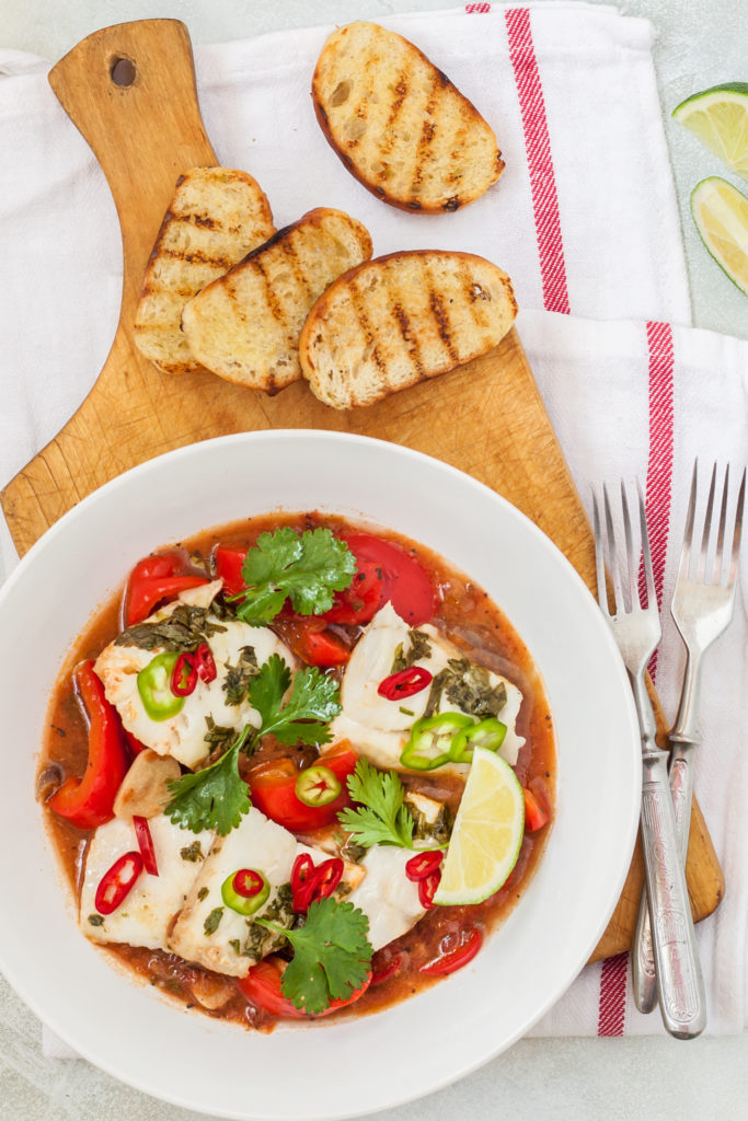Fish stew with chunks of white fish, tomatoes, herbs, chili peppers, lime served with crusty bread.