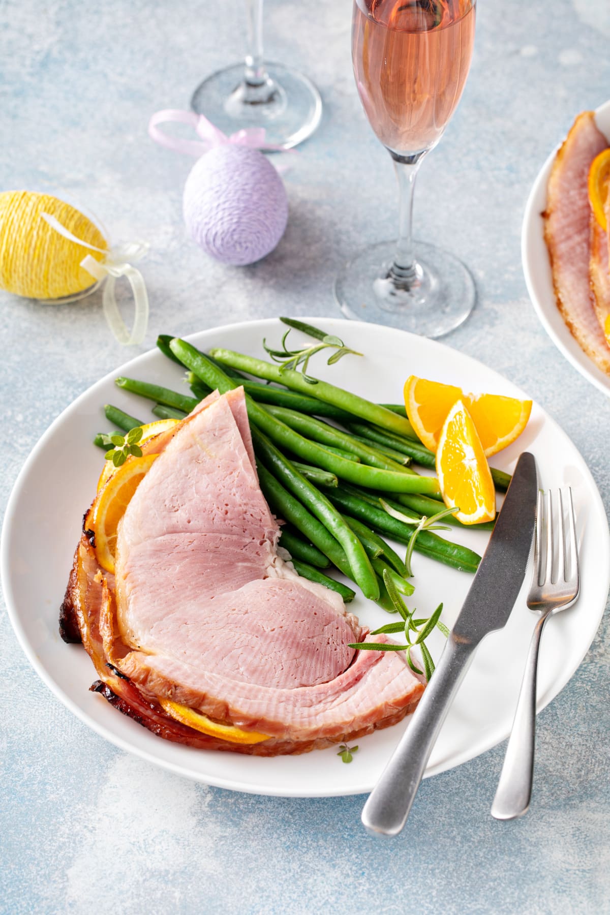 slices of heated baked ham served with green beans for Eater