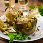 2 Instant Pot Artichokes served with dipping sauce and white wine