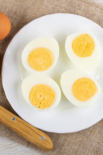 Instant Pot Hard Boiled Eggs cut in half using a cold knife and ready for eating or making deviled eggs, salads, or snacks