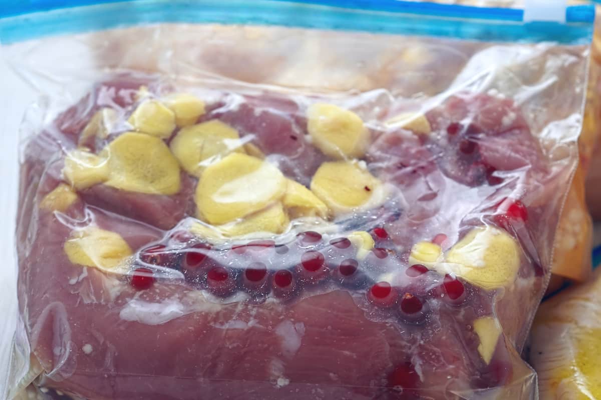 close up of zip-loc bag with marinade and pork chops inside